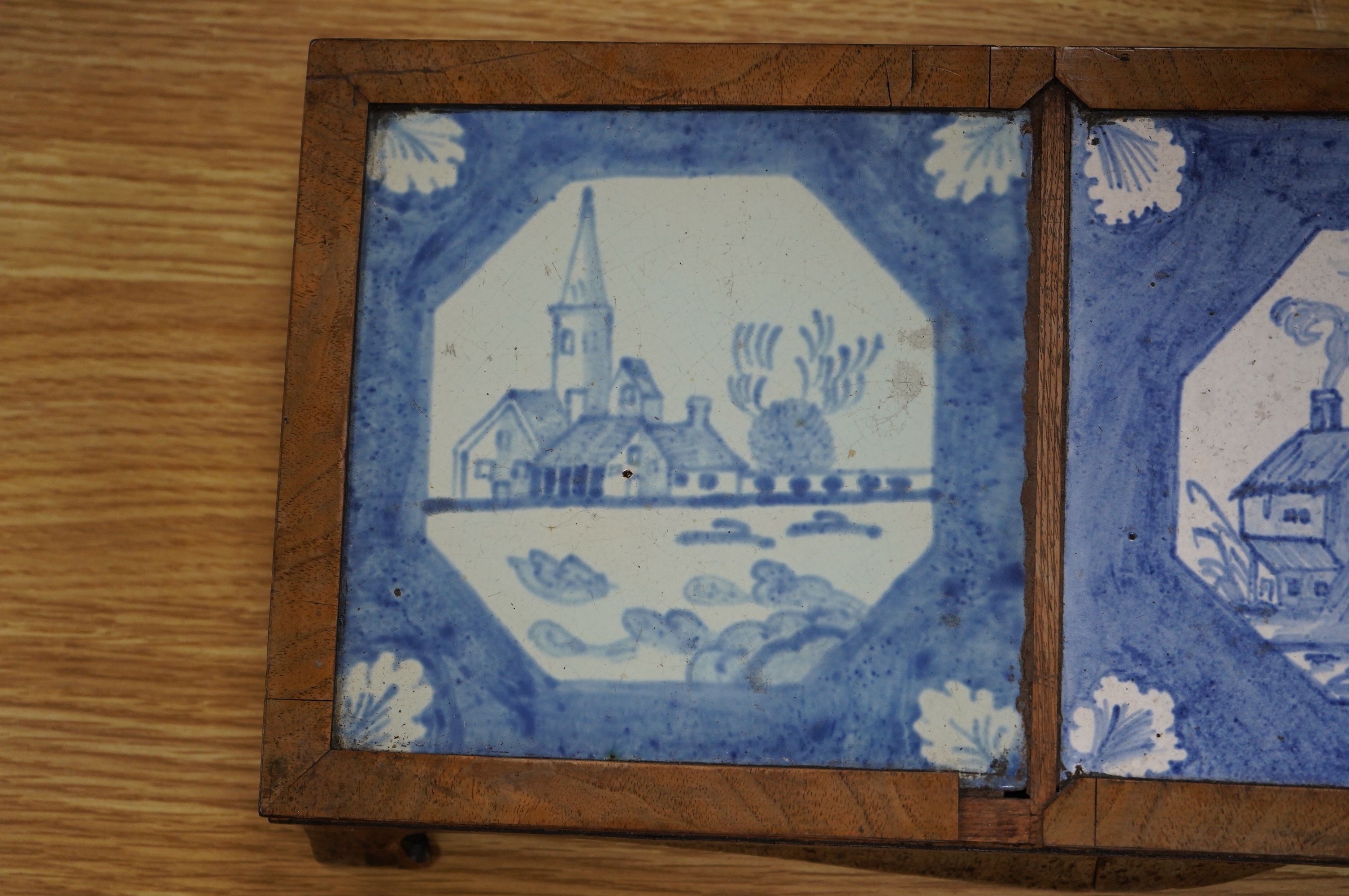 A 19th century Delft tile inset walnut stand, 49cm wide. Condition - poor